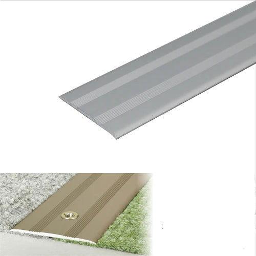 35mm Anodised aluminium flat door threshold profile installed in a doorway, providing a smooth transition and improved accessibility. gray- finishings UK