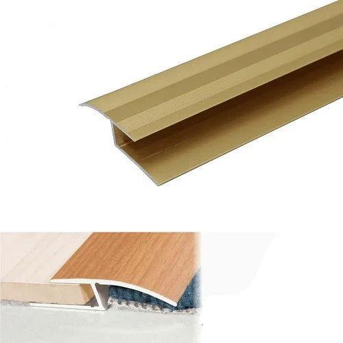 Anodised aluminium door threshold ramp profile installed in a doorway, providing a smooth transition and improved accessibility. gold- finishings UK