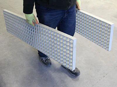 Standard Duty Sand Ladders, Waffle Boards For Snow, Mud, And Sand A man holding 2 waffle boards w- finishings UKite color