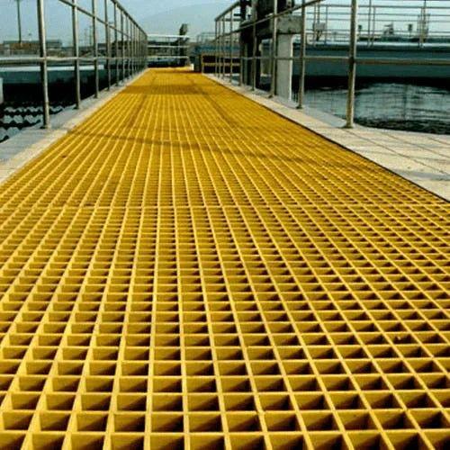 Yellow GRP floor grating panels providing safe, anti-slip access in an industrial UK facility.