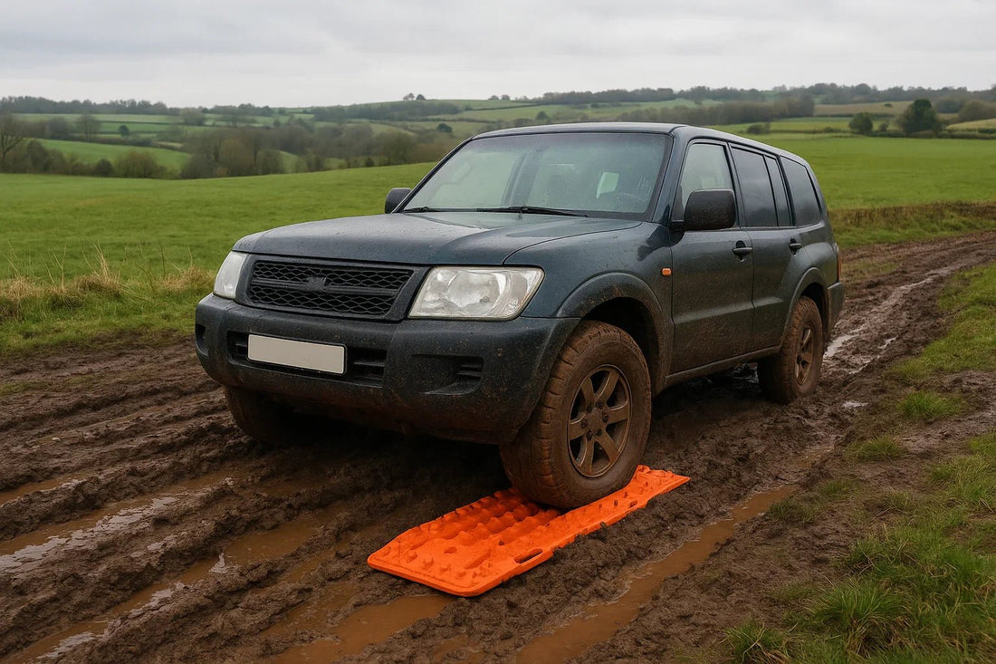 4x4 vehicle using bright orange recovery boards on muddy off-road track in the UK countryside