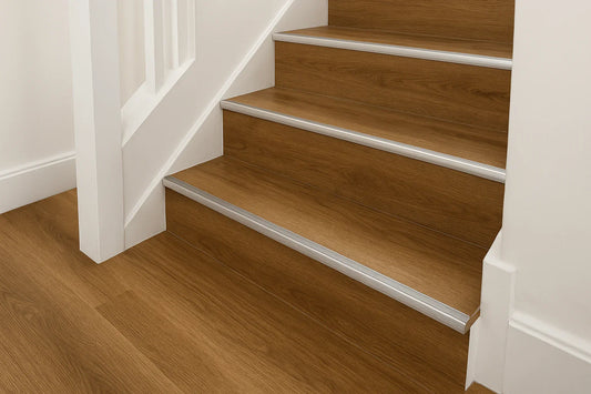 Modern UK staircase with luxury vinyl tile (LVT) flooring and aluminium stair nosing trim for safe and stylish edge protection.