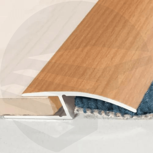 Close-up of an anodised aluminium door threshold ramp profile, showcasing its sleek finish and textured surface for slip resistance wood color- finishings UK