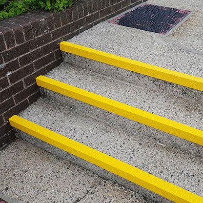 Screw Down Aluminium Anti-Slip Stair Treads in use on a commercial staircase.Anti-slip GRP step nosing for public stairs