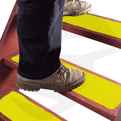 Anti-slip tape for stairs installed on indoor steps for added safety. yellow color