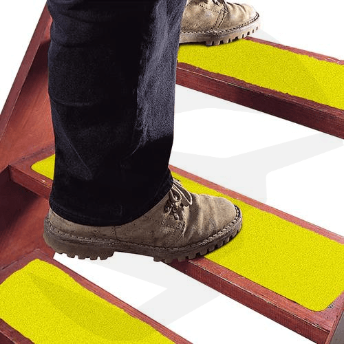 Anti-slip tape for stairs installed on indoor steps for added safety. yellow color